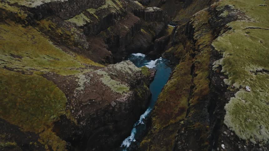 A waterfall becomes a winding river