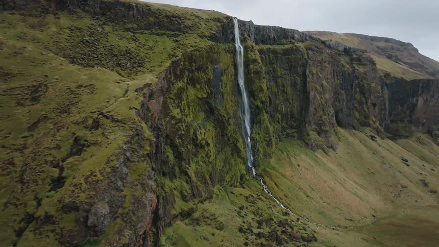 A waterfall cascades down a cliff