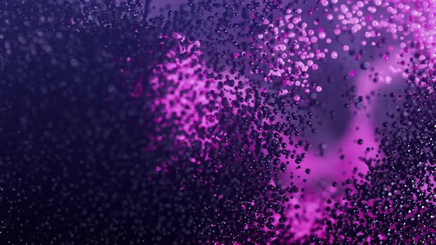 Shimmering pink particles against a dark background