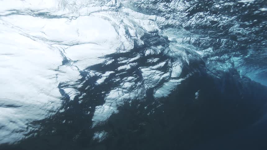The wave slowly forms and rolls underwater