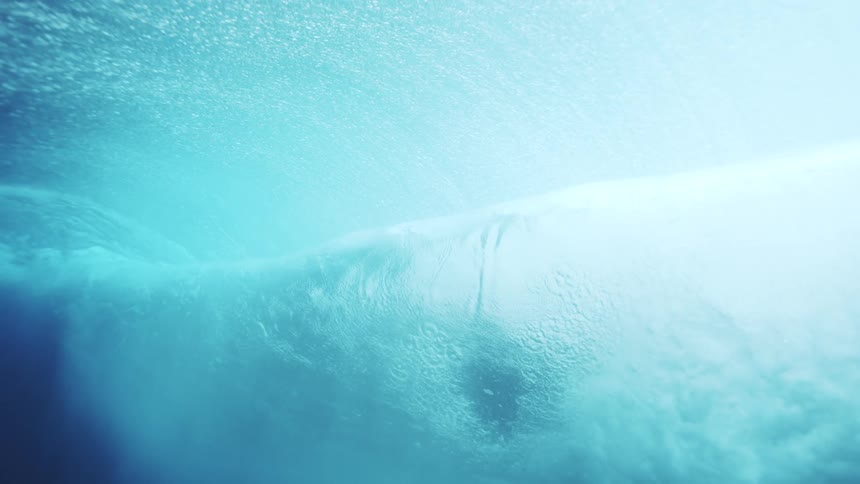 Crystal blue wave seen from beneath the ocean surface