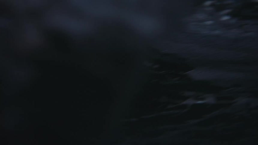 A wave washes over the camera