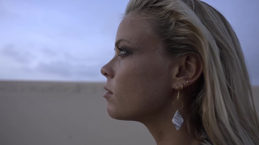 Woman gazing into the desert landscape at dusk