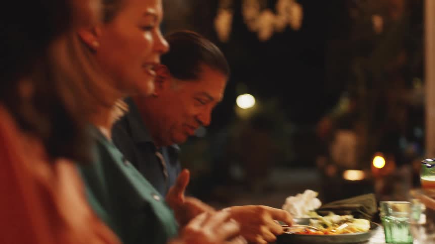Woman holds her hands together in prayer before dinner