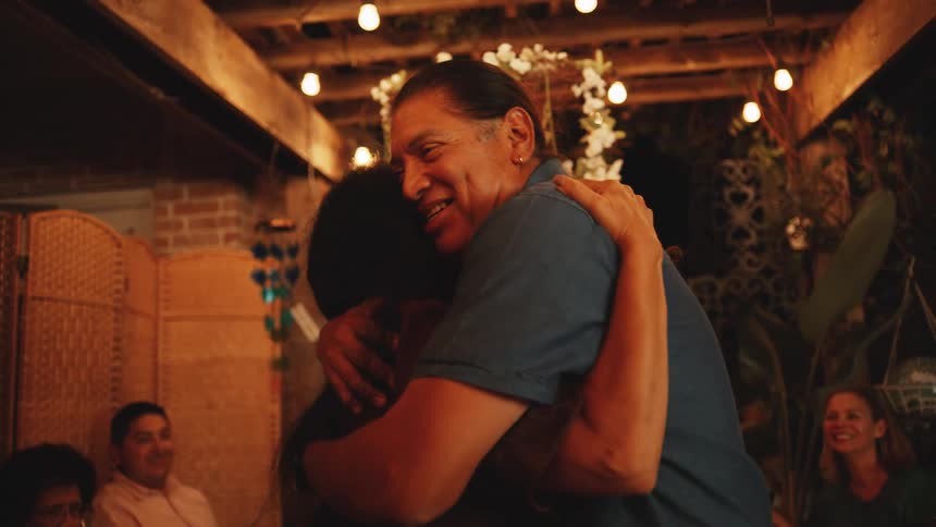 The man and woman hug while dancing