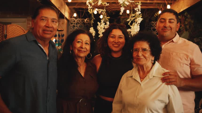 Happy family posing at night with restaurant lights in the background