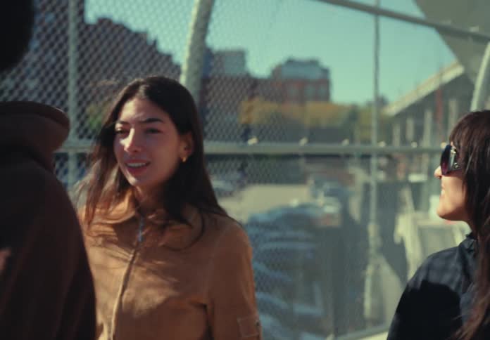 Two friends smile as they travel over the overpass