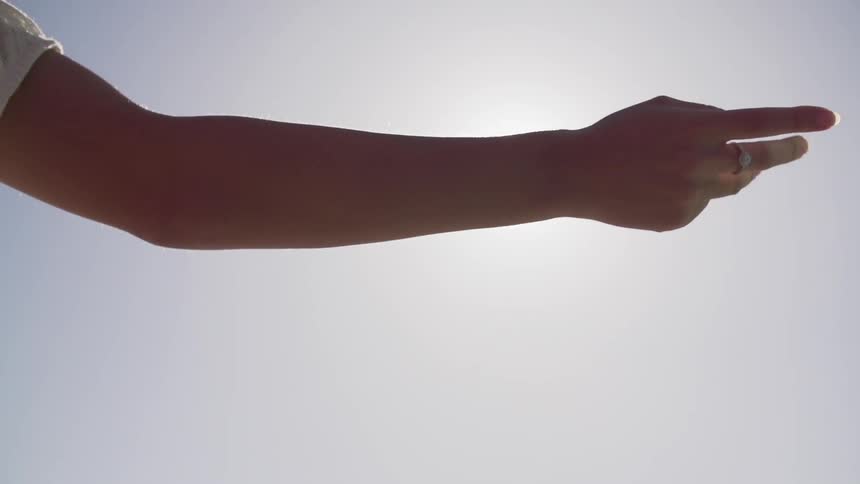 Hand dragging along the side of a building