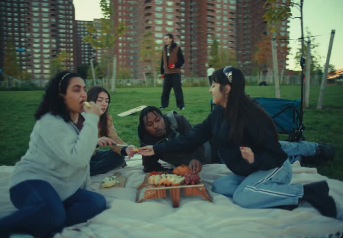 Friends are eating fruit at a picnic