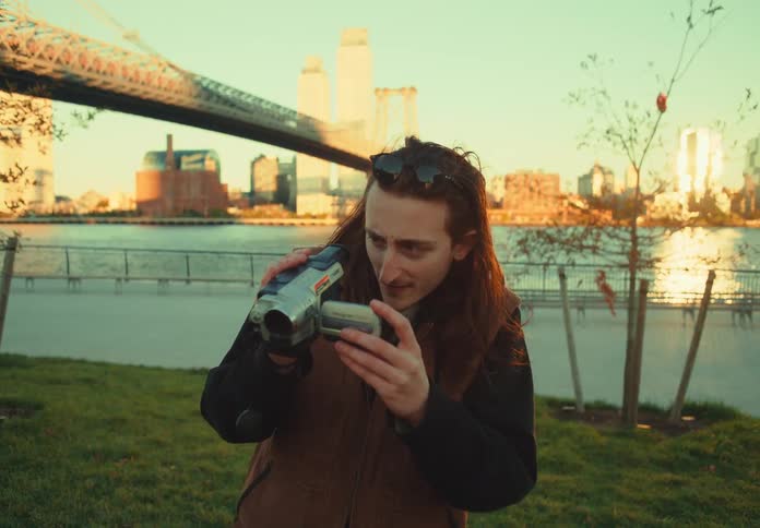 A camera man smiles at the camera