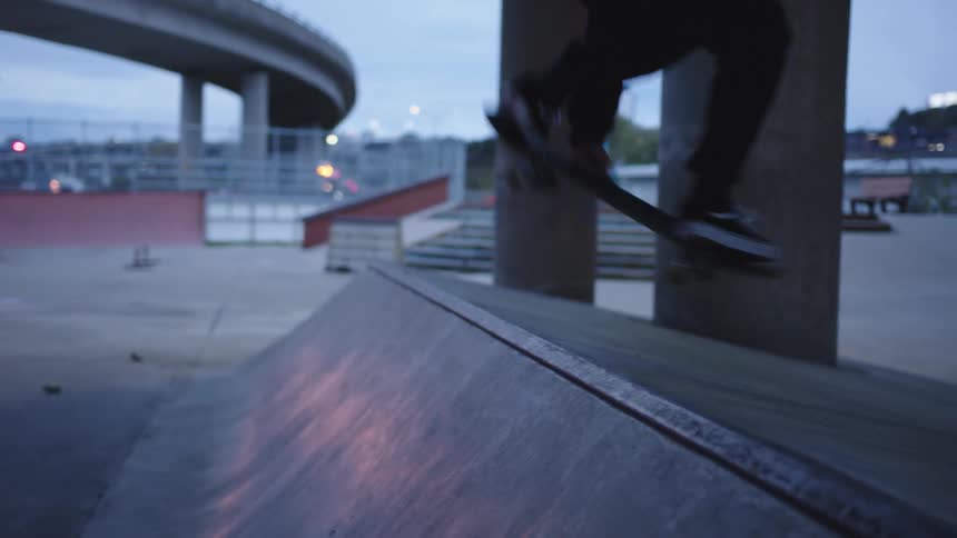 The man jumps over the ramp on his skateboard