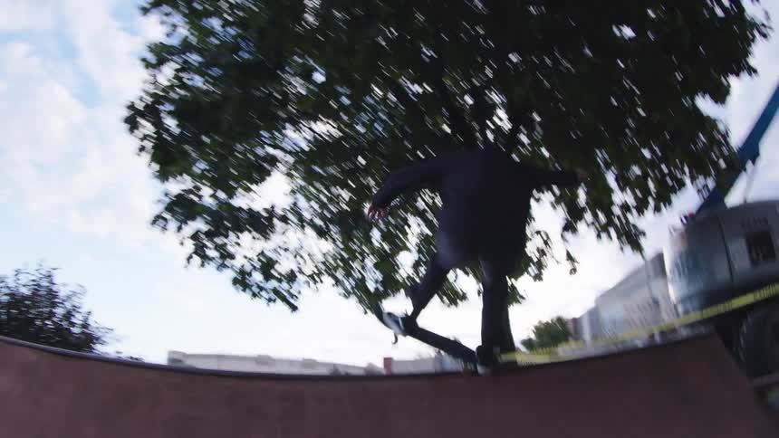 A man skateboarding up a ramp