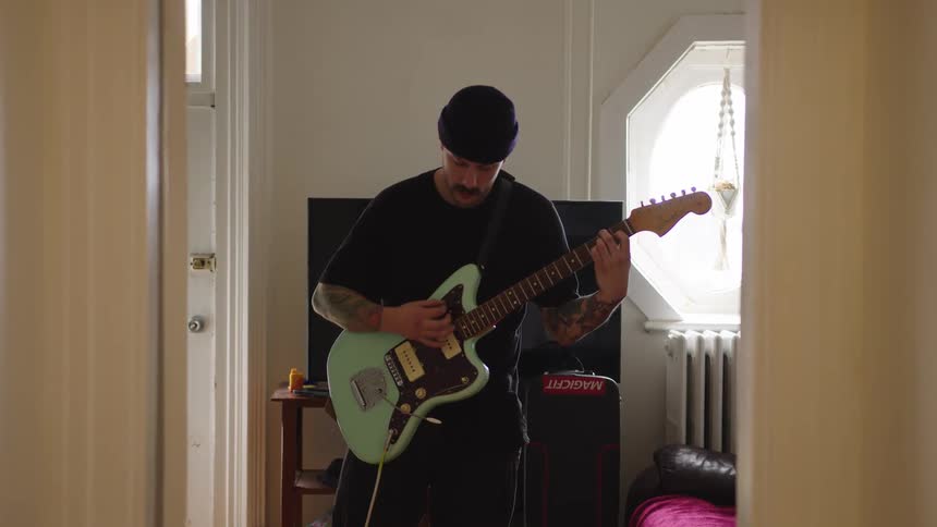 The man plays the guitar