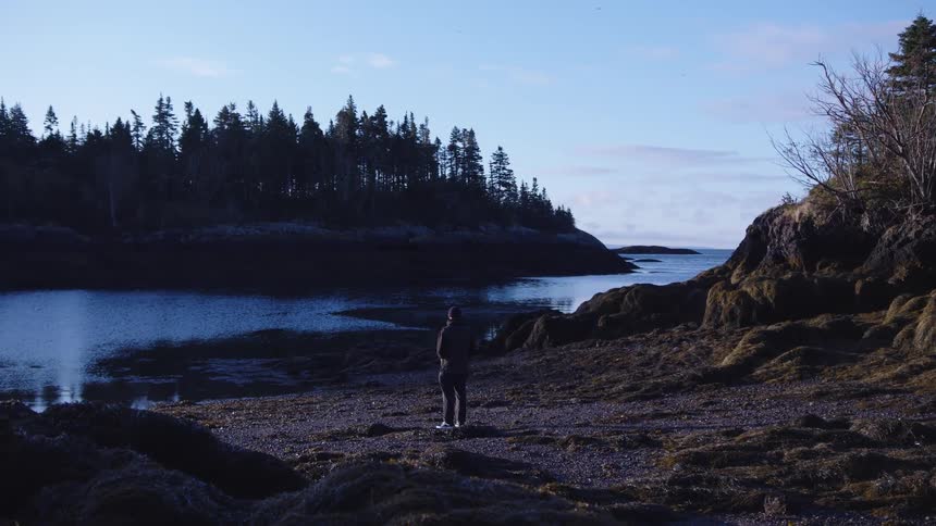 The man stands by the riverbed