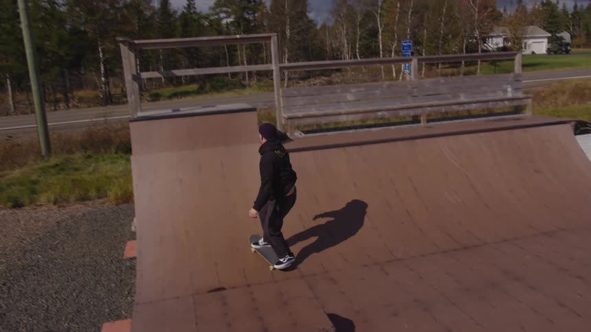Skateboarder performing a trick on an outdoor ramp
