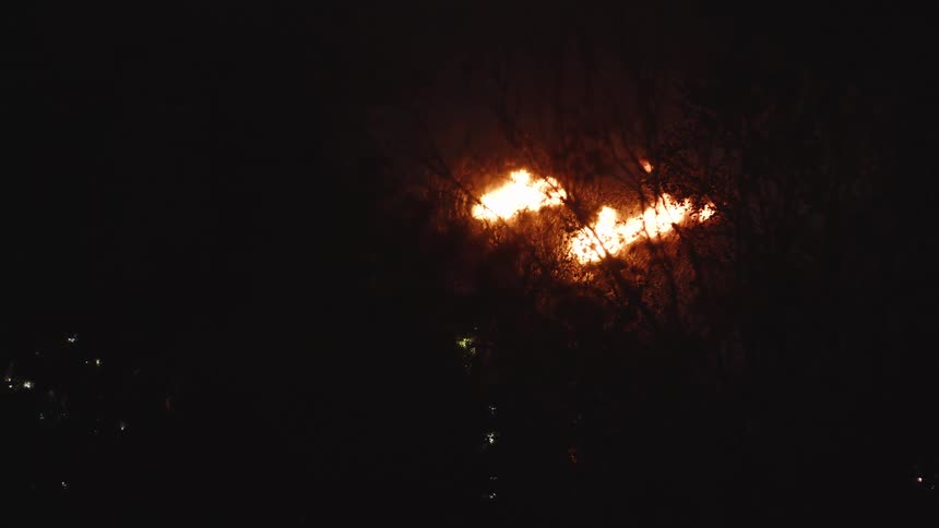 A fire blazes in the night