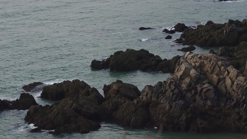 Waves crash along the rocks