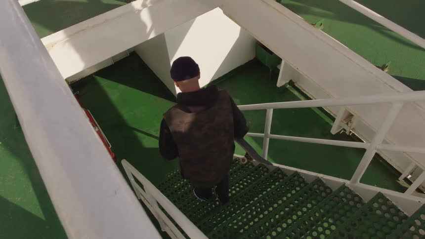 The man is walking down the stairs