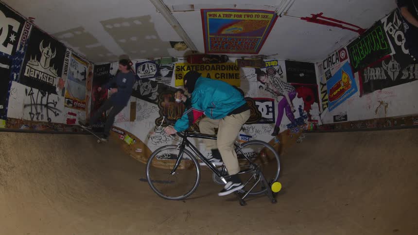 Two teenagers ride around another teenager on the stationary bike