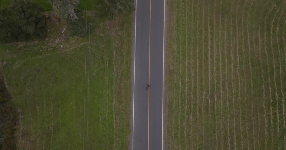 The man runs down the center of the road
