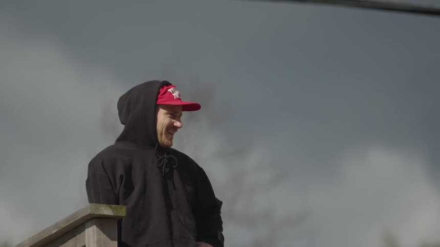 The man talks and smiles on a cloudy day