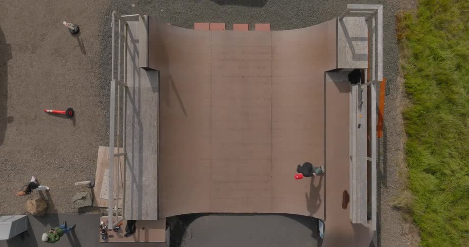 Aerial view of a skateboarder in a half pipe at a skatepark