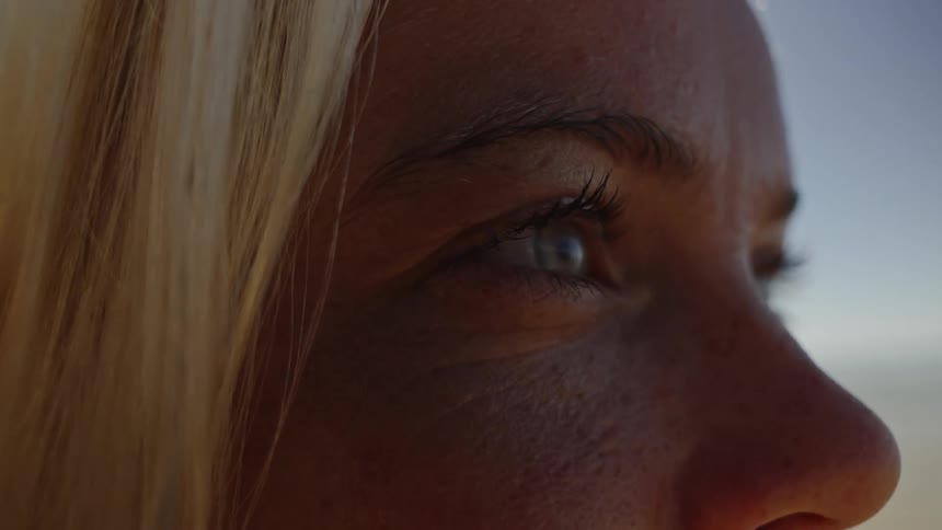 Closeup of a woman gazing at the horizon under soft natural light