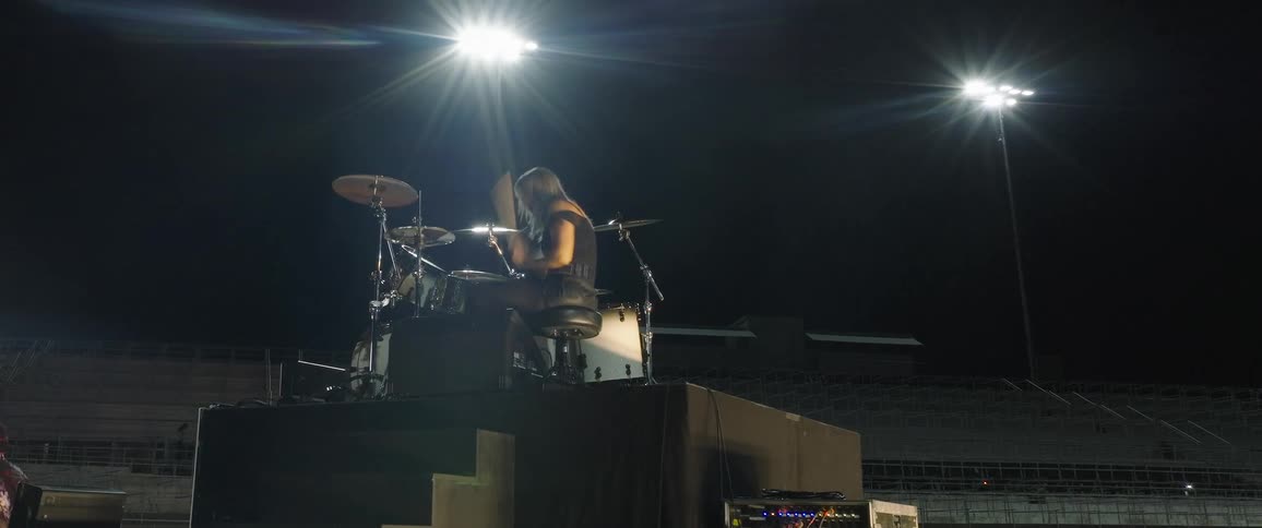 A drummer plays in a stadium