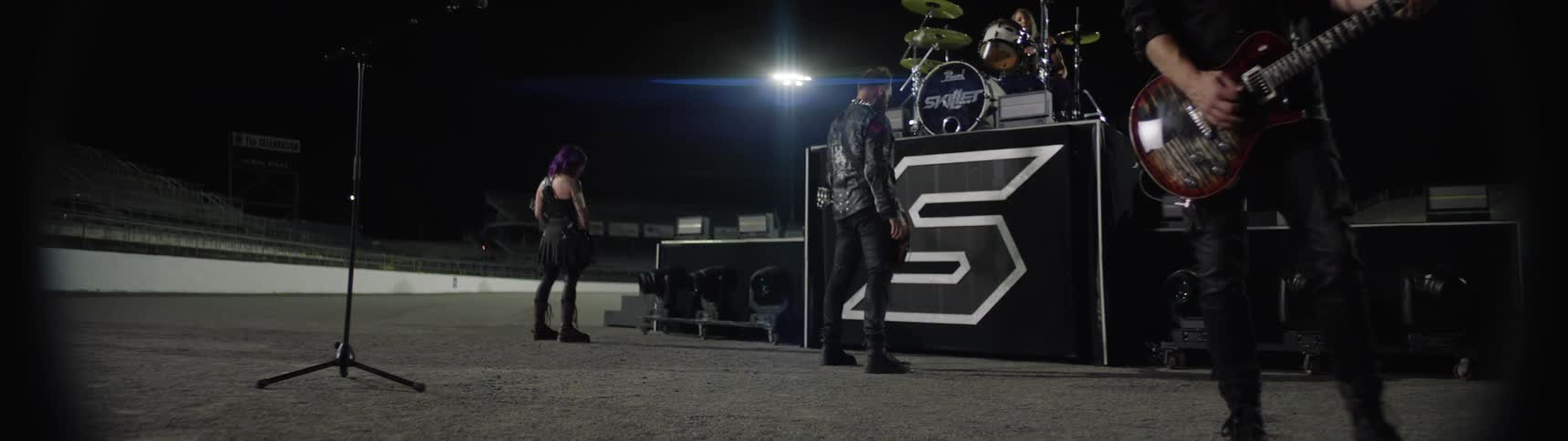 A music band rehearsing and preparing on stage for a night concert at an arena