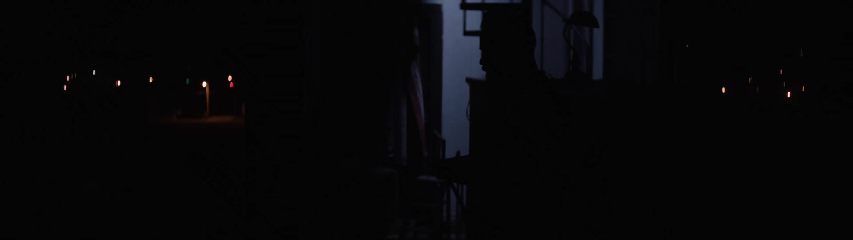 Man in a stadium booth turning off the lights after the night event