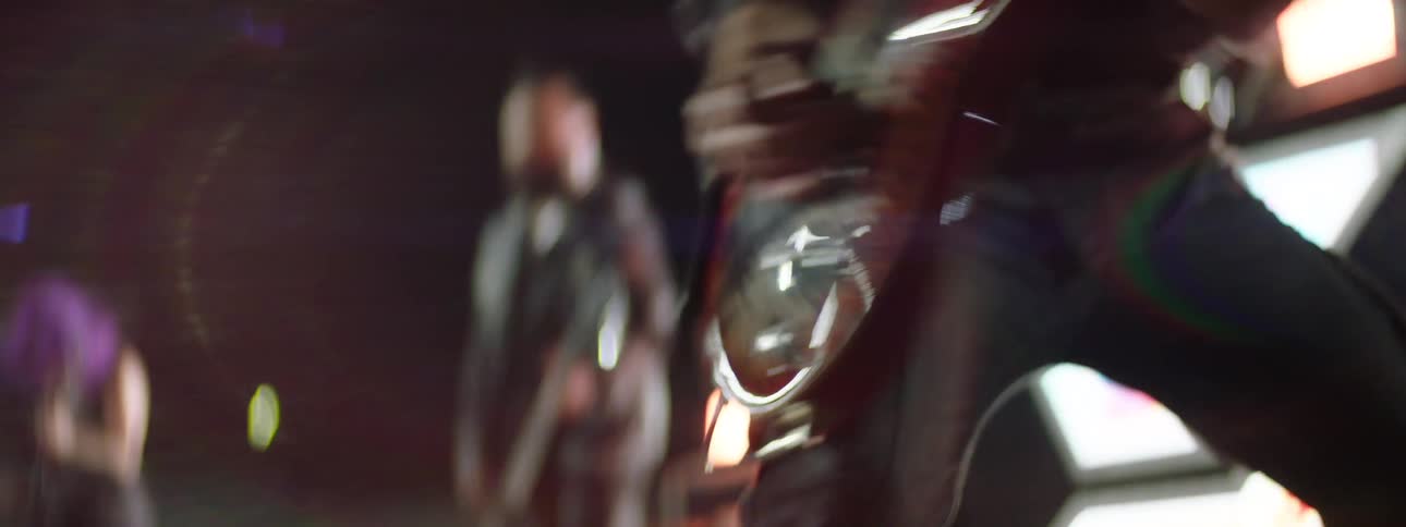 Guitarist plays chords intensely under colorful stage lights