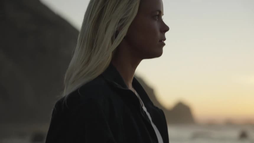 A woman standing on the beach