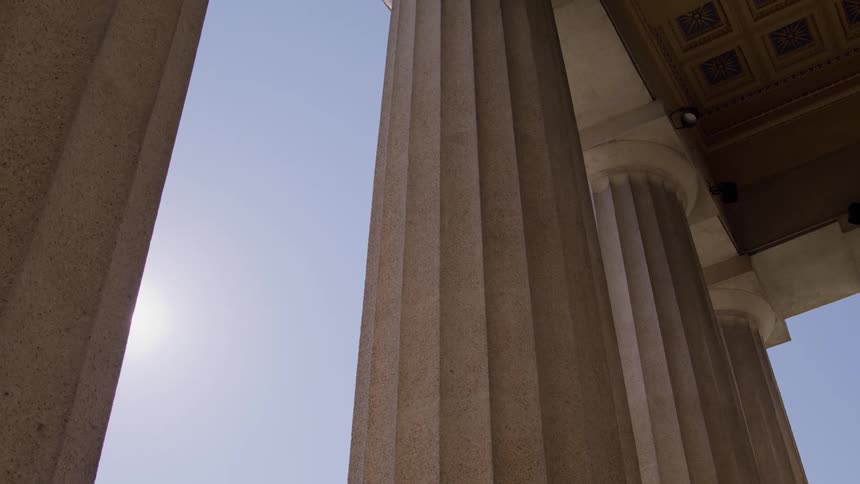 Sun shines between pillars