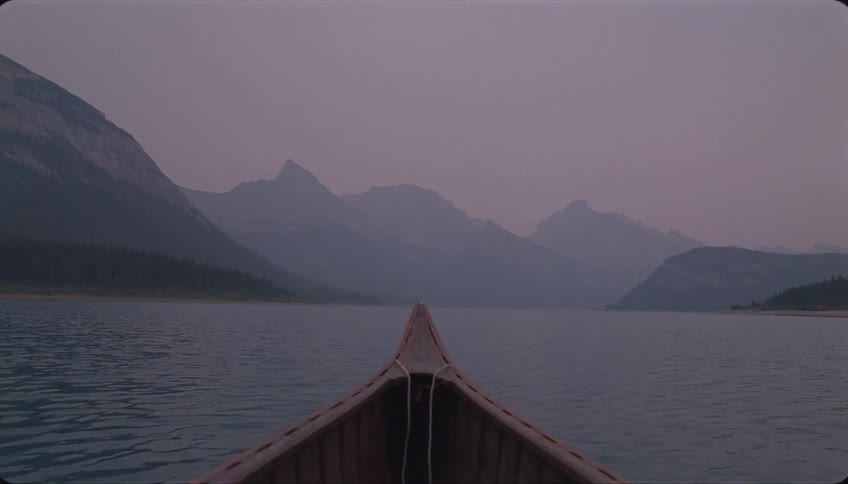 Heading across the lake to the mountains in a canoe