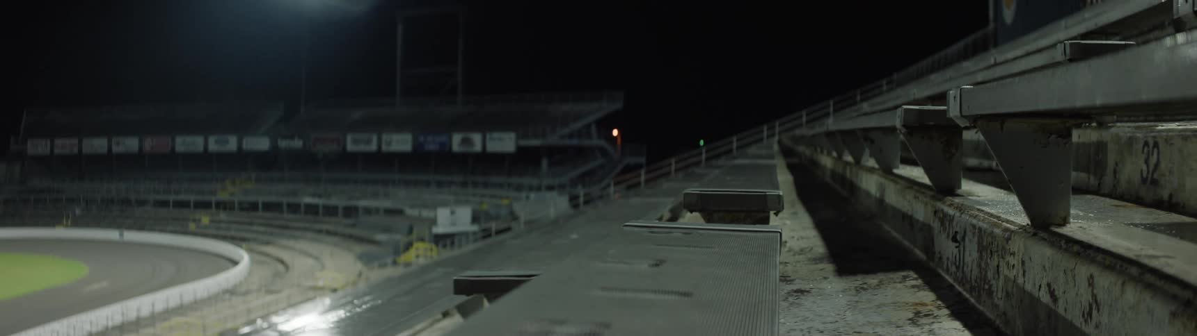 The video is an extreme closeup shot of a smooth ribbed metal surface moving past the camera likely part of an industrial machine or track the surface has shallow grooves and etchedout numbers along its path which are blurred by the quick mo