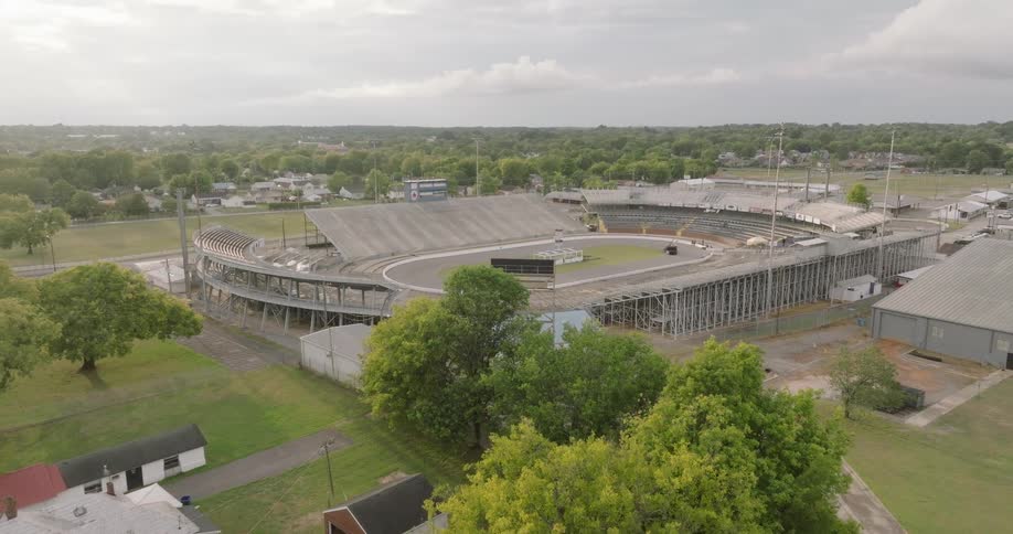 Aerial view of an oval stadium surrounded by suburban houses