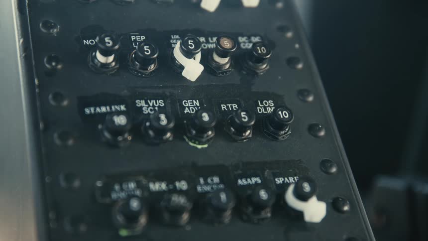 The video is an extreme closeup shot of a dark control panel featuring two rows of five black rotary knobs each labeled with white lettering and numbers white directional arrows indicate the rotation for increasing the corresponding valuethe v