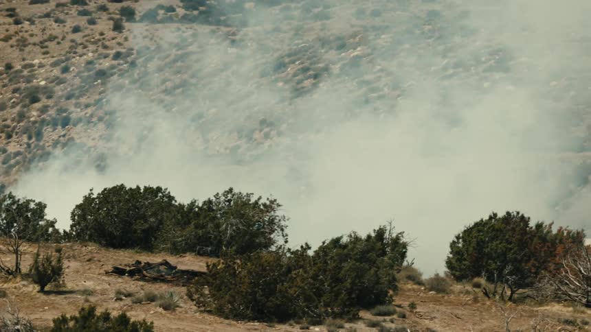 Thick white smoke flowing through the hillside