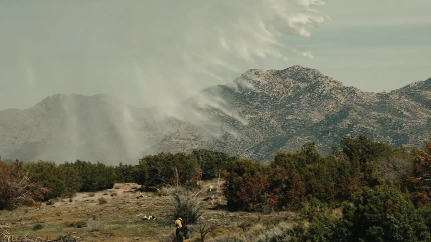 Mountains covered by moving clouds