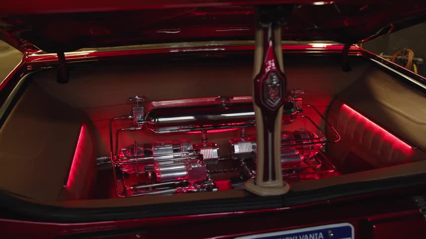 Customized trunk with a chrome hydraulic system illuminated by red light