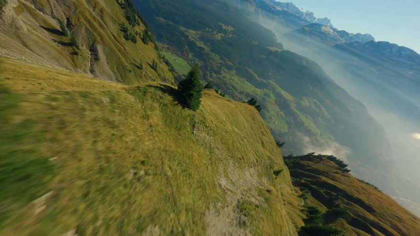 FPV Drone flies over swiss mountains