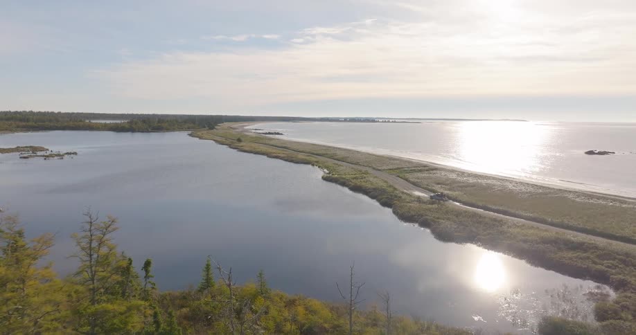 The vehicle drives on the shore line