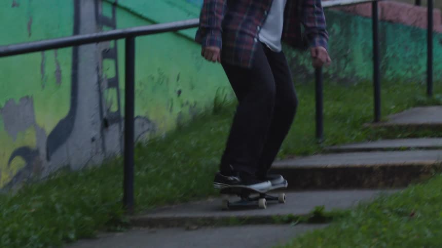 A man skating down a stairway slope