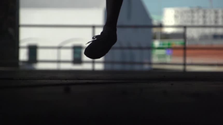 Man kicks a soccer ball and jumps