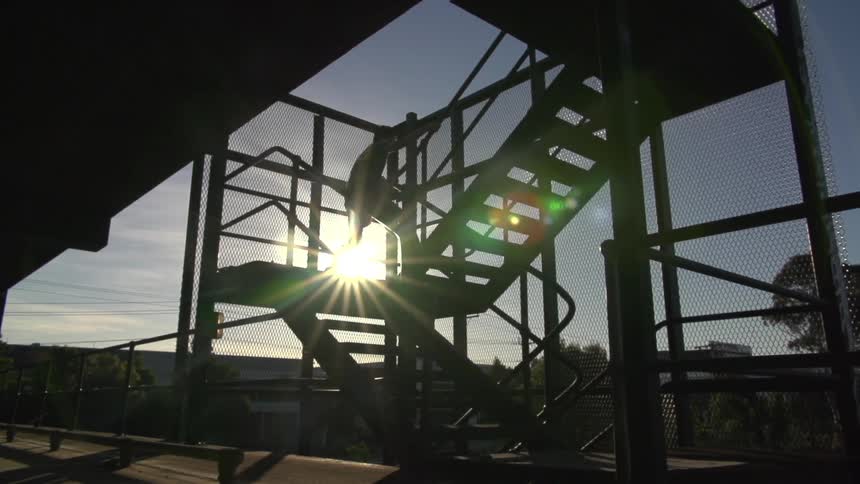 Person running up train platform stairs