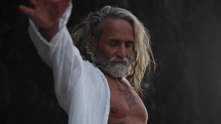 The man stretches his arm up