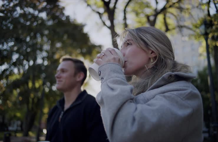 The man and woman drink coffee then kiss