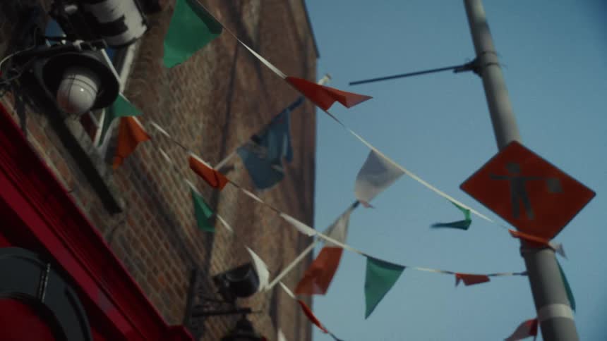 Wind is blowing the flags hanging from the building