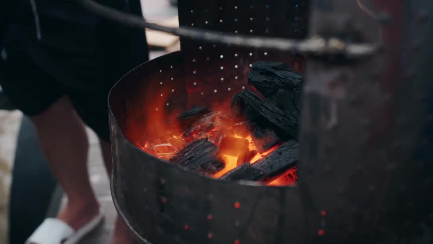 Wood is burning in the metal bin
