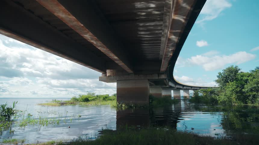 The overpass winds around the water of the shoreline
